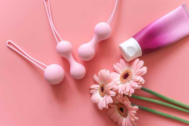 Pink balls and lubricant for special exercises for woman. Balls for intimate muscles of women. Kegel balls for strenthening the pelvic floor muscles, vaginal muscles. Mock up. Close up - Photo, Image
