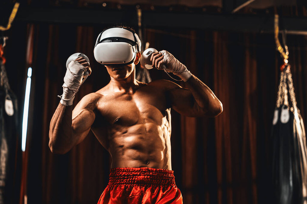 Trening bokserski z wykorzystaniem technologii VR lub wirtualnej rzeczywistości, noszenie zestawu słuchawkowego VR z wciągającą techniką treningu bokserskiego za pomocą kontrolera w celu zwiększenia jego umiejętności w środowisku symulatora boksu. Impetus - Zdjęcie, obraz