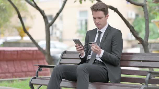 Businessman Shopping Online while Sitting on Bench - Footage, Video