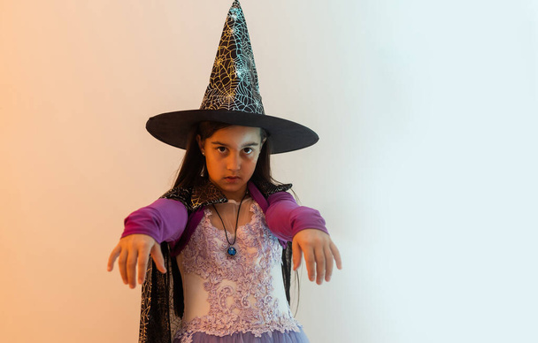 teenage girl in a witch costume, happy halloween holiday - Zdjęcie, obraz