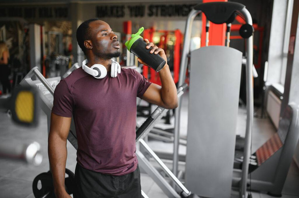 Young athletic African American man in the gym. - Фото, зображення