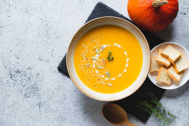 Roasted pumpkin and carrot soup with pumpkin  and hemp seeds. Pumpkin traditional soup with creamy silky texture - Photo, Image