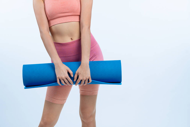Young attractive asian woman portrait in sportswear with exercising mat. Healthy exercise and workout routine lifestyle concept. Studio shot isolated background. Vigorous - Foto, Bild