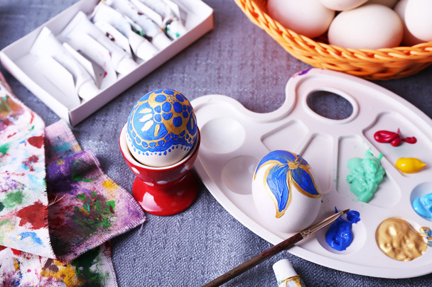 Painting Easter eggs on colorful tablecloth background - Foto, imagen