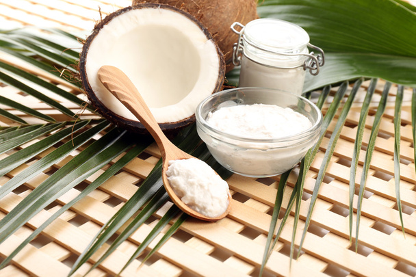 Coconut with leaf and coconut oil in jar on wooden background - Zdjęcie, obraz