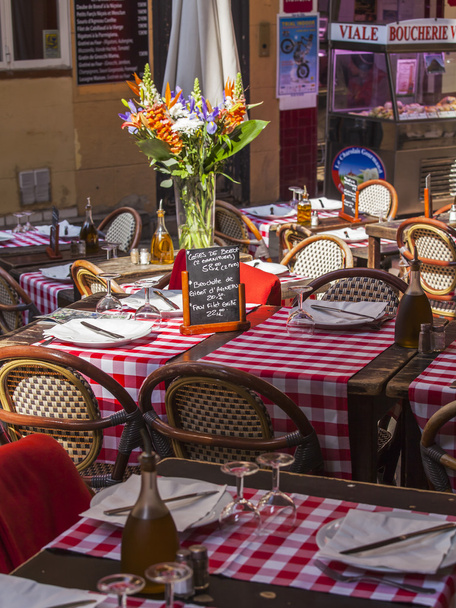 Nice, France, on March 13, 2015. Little tables of street cafe in Provencal style in the old city - Zdjęcie, obraz