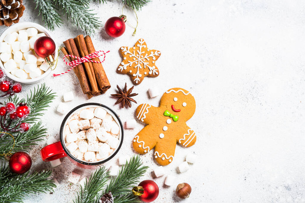 Noel yemeği. Marşmelovlu sıcak çikolata ve beyaz masada tatil süslemeleri olan zencefilli kurabiye. Kopyalama alanı olan üst görünüm. - Fotoğraf, Görsel
