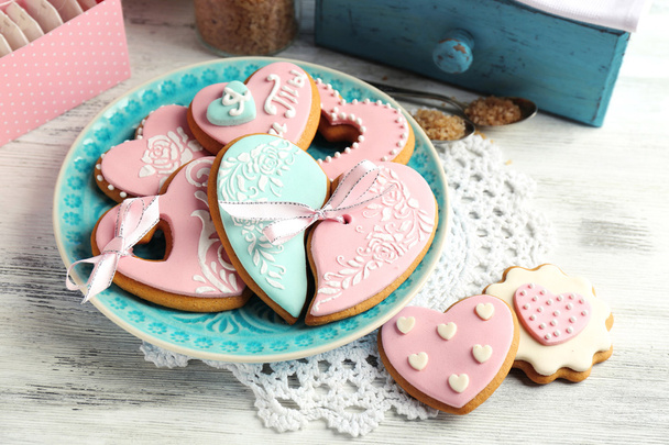Heart shaped cookies for valentines day on plate, on color wooden background - Valokuva, kuva