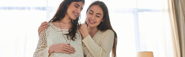 happy lgbt couple hugging warmly with hand on pregnant belly with closed eyes, ivf concept, banner - Photo, Image