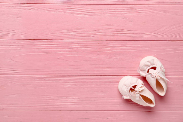 Stylish baby booties on color wooden background - Photo, Image