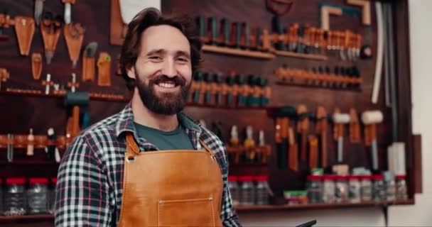 Leather workshop, portrait of happy man with tools, craft manufacturing and unique textile product. Smile, small business owner and factory craftsman with confidence, pride and repair service store - Footage, Video