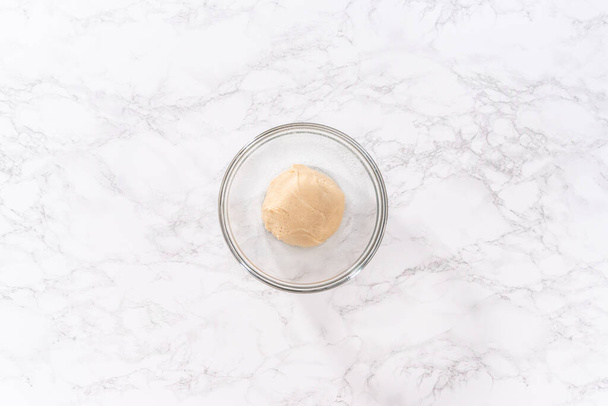Flat lay. Mixing ingredients in a large glass mixing bowl to pizza dough. - Photo, Image