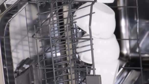 食器洗い機からの皿の荷を下すこと. 洗練された光沢のある食器洗い機. バーティカルビデオ - 映像、動画