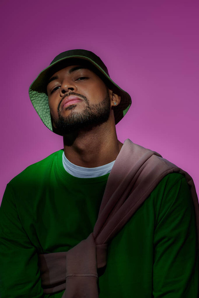 young bearded african american man in green sweatshirt with diamond earring, fashion concept - Photo, Image