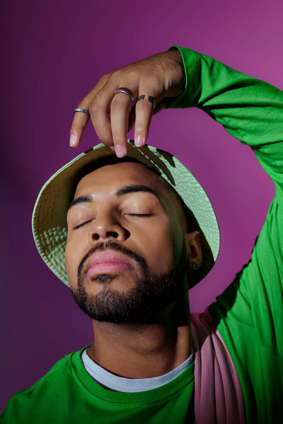 close up young african american man in green panama posing with closed eyes, fashion concept - Photo, Image