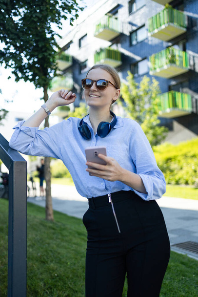 Young elegant professional leader Caucasian woman, female executive retail manager supervisor, small business owner wearing suit holding digital tablet standing outdoor looking at camera, portrait. - Foto, Bild