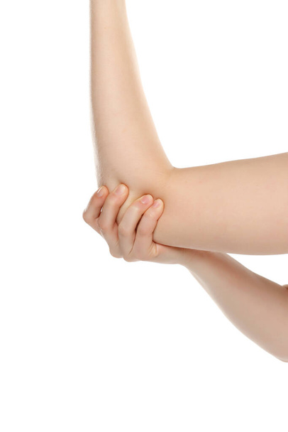 Cropped image woman with joint inflammation. Female's elbow on a white studio background - Photo, Image