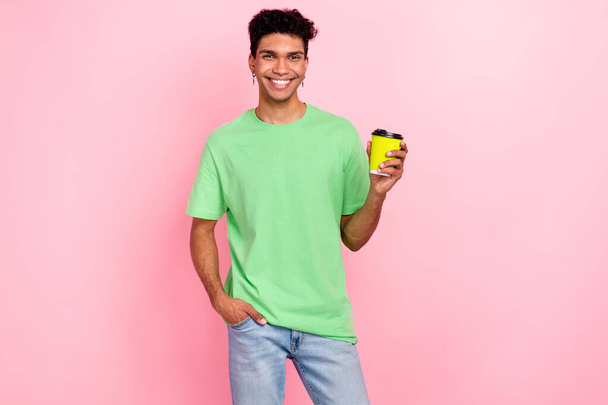 Photo of nice cheerful funky guy dressed green trendy clothes walk enjoy caffeine refreshing drink isolated on pink color background. - Foto, immagini