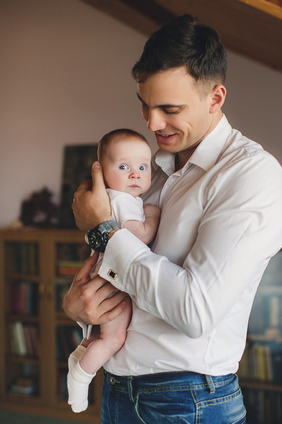 Happy father with his newborn daughter in his house. - Valokuva, kuva