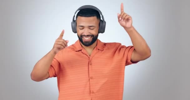 Man, dancing and headphones with music and energy, fun and happy with disco or techno isolated on white background. Listening to audio, radio and subscription with streaming and dancer in studio. - Footage, Video