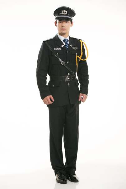 Create all kinds of work clothes policeman stands in front of a white background - Foto, Imagem