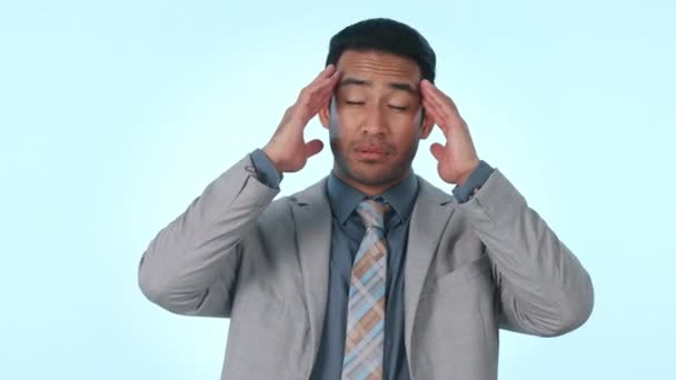 Businessman, headache and stress in pain, anxiety or mental health against a studio background. Tired asian man or business employee with migraine in depression, pressure or burnout on mockup space. - Footage, Video