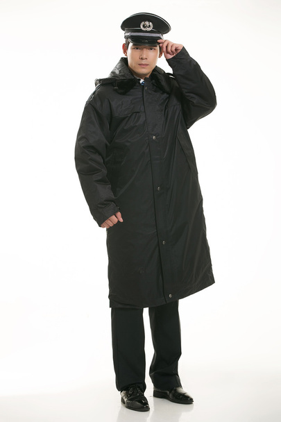 Create all kinds of work clothes policeman stands in front of a white background - Photo, Image