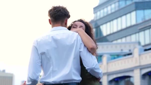 Smiling young couple dancing on a rooftop against building. Romantic date on the roof. Romantic concept. Couple in love. Real time - Footage, Video