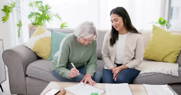 Financial advisor, senior woman and handshake for asset management, agreement and signature or contract documents. Broker or notary shaking hands with elderly client on home sofa for pension success. - Footage, Video
