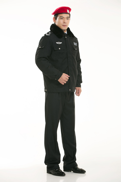 Créer toutes sortes de vêtements de travail policier se tient devant un fond blanc - Photo, image