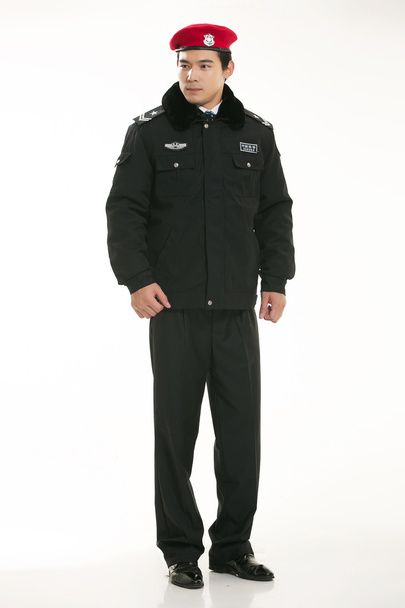 Δημιουργήστε όλων των ειδών τα ρούχα εργασίας αστυνομικός στέκεται μπροστά από ένα λευκό φόντο - Φωτογραφία, εικόνα