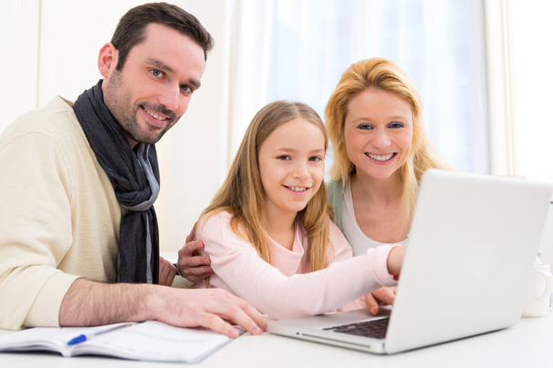 Happy family in front of a laptop - Fotó, kép