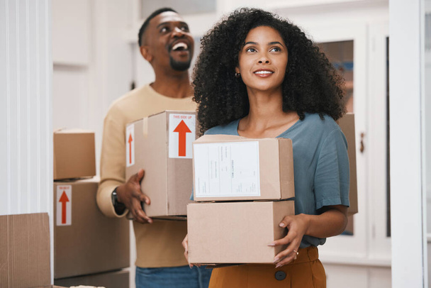 Happy black couple, box and moving in new home, real estate or investment for property together. African man and woman smile with boxes in renovation, relocation or house mortgage and apartment loan. - Foto, Imagem