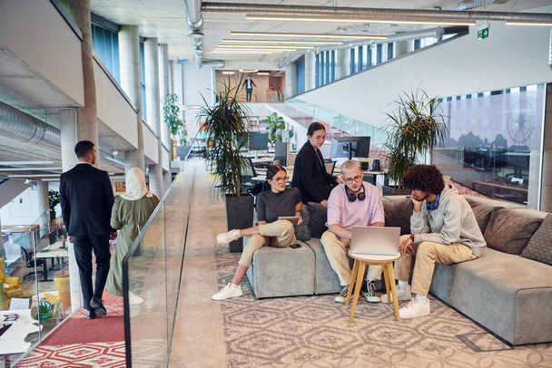 In a modern startup office, a diverse group of young professionals collaboratively tackles various business problems and challenges, surrounded by their engaged colleagues, fostering innovation and - 写真・画像