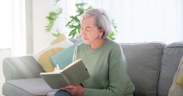Relax, morning and a woman writing in a notebook for a memory, planning retirement or reflection. Remember, calm and an elderly person on the home sofa with a journal or diary for notes and ideas. - Video, Çekim