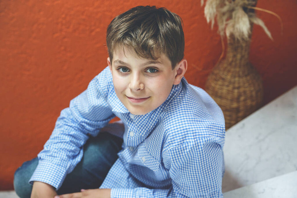 Handsome Teenager Boy Poses Indoors, Exuding Confidence and Style in a Captivating Portrait. Happy Preteen Child - Photo, Image