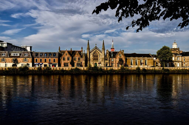 Journey back in time with this evocative image featuring the historic houses along Ness Walk, situated by the River Ness in Inverness, Scottish Highlands. These stately homes stand as silent witnesses - Photo, Image