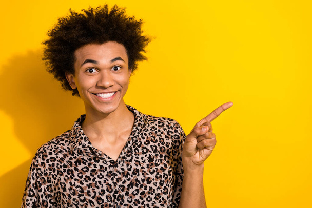 Photo of fan brazilian football team youngster guy wear leopard shirt indicate finger mockup his barber isolated on yellow color background. - Zdjęcie, obraz