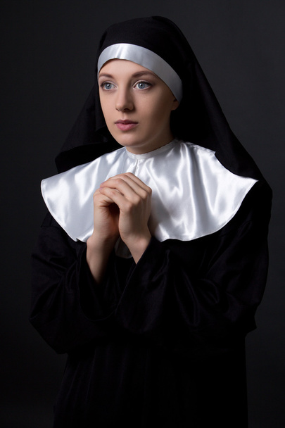 religion concept - praying nun over grey - Φωτογραφία, εικόνα