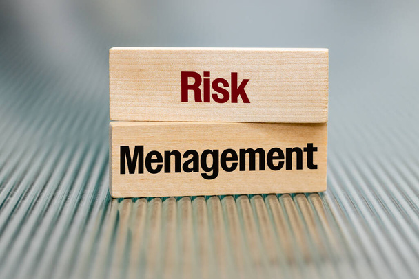 Risk management text on wooden blocks Business concept, financial, technological, legal risk management, security of data, facilities, supplies, proper functioning of production lines in the company - Photo, Image