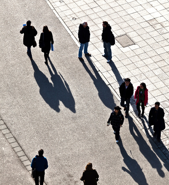 walking at the street with long shadows - Photo, Image