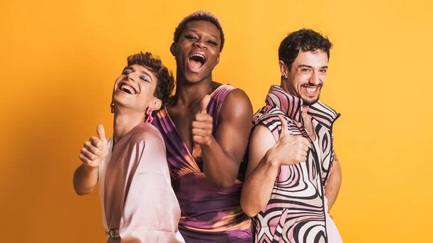 three multiethnic transgender men gesturing to be fine with the thumb up while posing in a photographic studio - Photo, Image