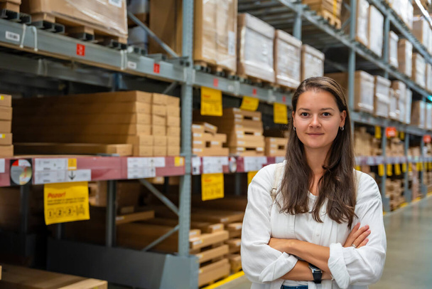 Portrait of woman customer or store worker with shelves in storage as background. High quality photo - Photo, Image
