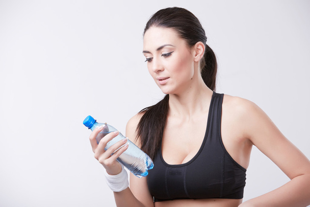Sporty woman with bottle of water  - Photo, image