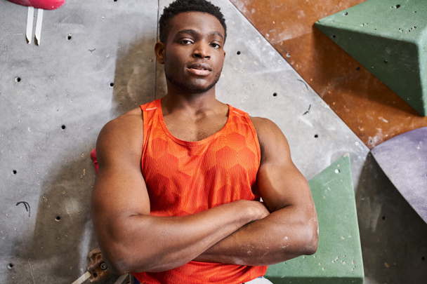 african american man smiling with arms crossed on chest posing next to climbing wall, bouldering - Photo, Image