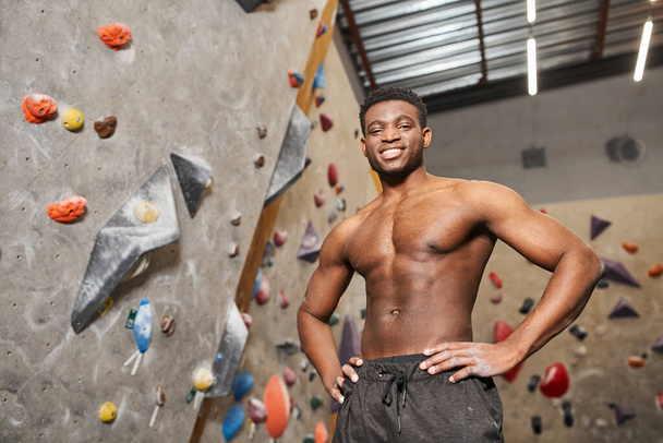 cheerful shirtless african american man posing with his hands on hips and smiling at camera - Photo, Image