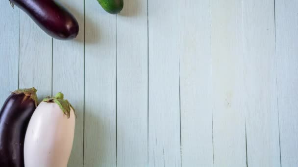 Fresh ripe vegetables fall, sliding on white wooden table. Stop motion animation - Footage, Video