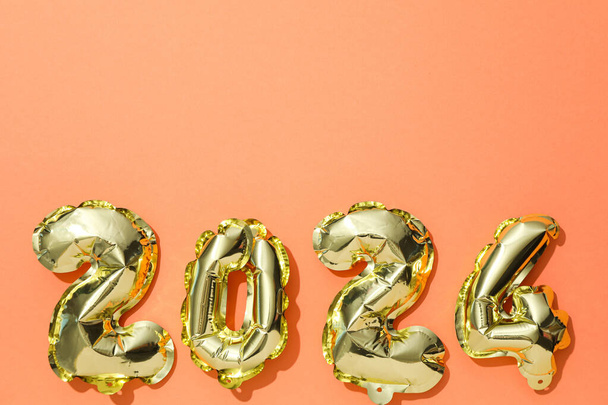 Año Nuevo 2024 con globos dorados sobre un fondo claro - Foto, Imagen