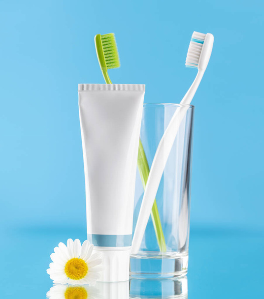 A clean and refreshing image featuring toothpaste and toothbrushes, promoting oral hygiene and a bright smile - Photo, Image