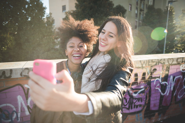 Two multiethnic girls taking selfie - Photo, Image